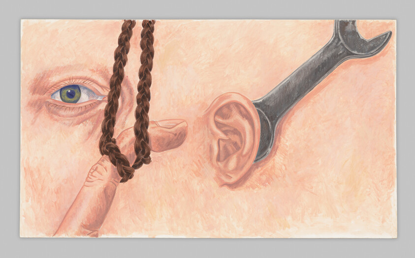 A finger holds a braided loop near a face while a wrench is lodged in the ear.