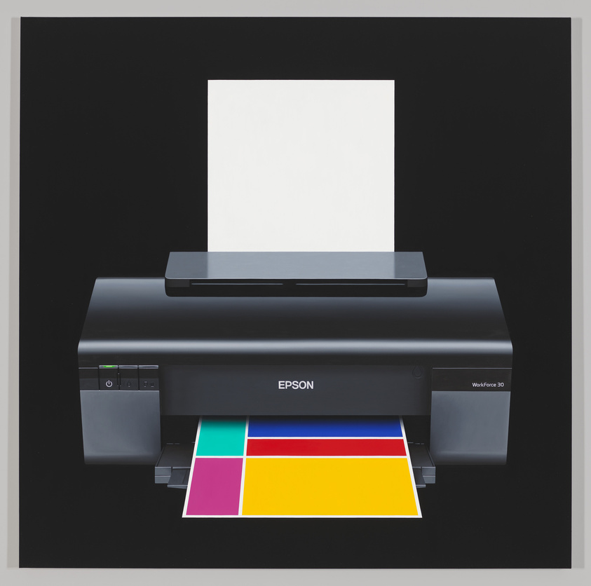 Desktop printer on black background. White sheet of paper feeding and colorful paper printing.