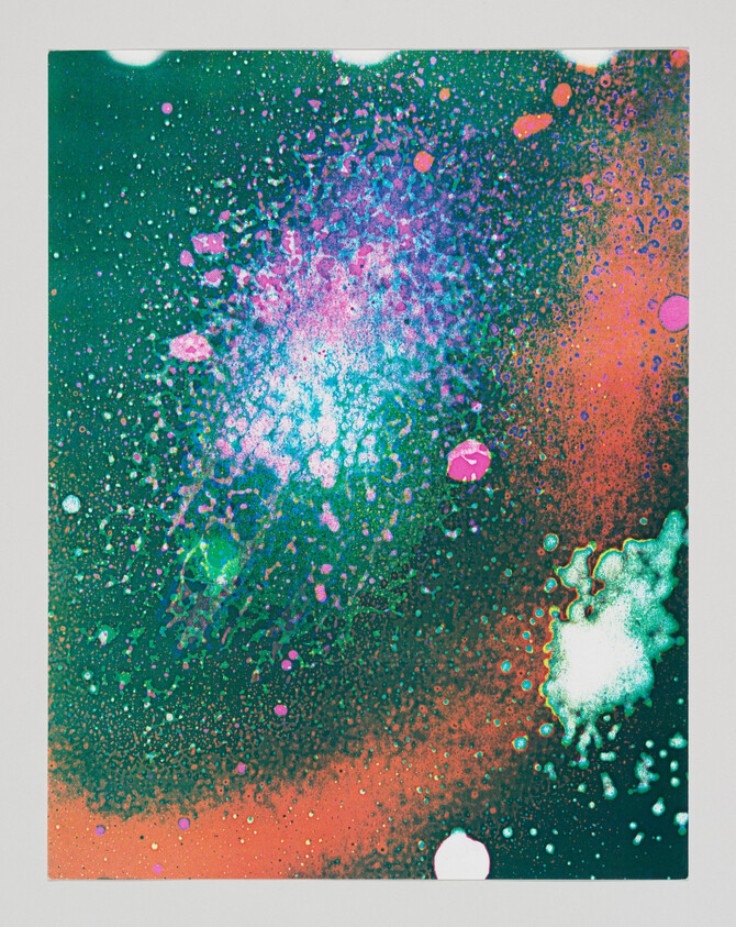 Bright teal, pink, and orange paint splatters spread across a dark green background like a galaxy.