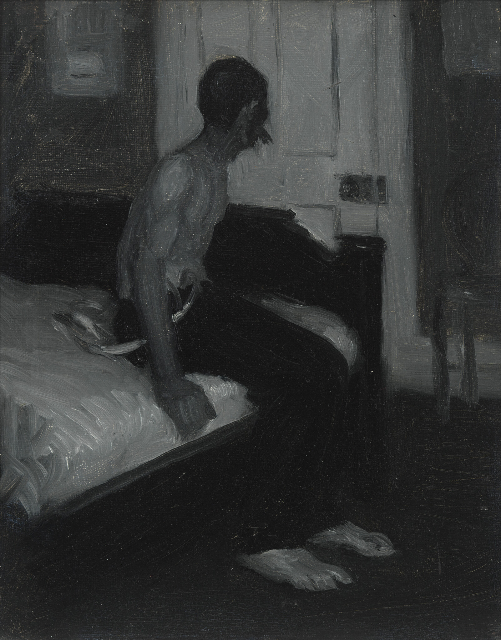 A man sits on the edge of a bed in a dim room, looking toward a closed window.