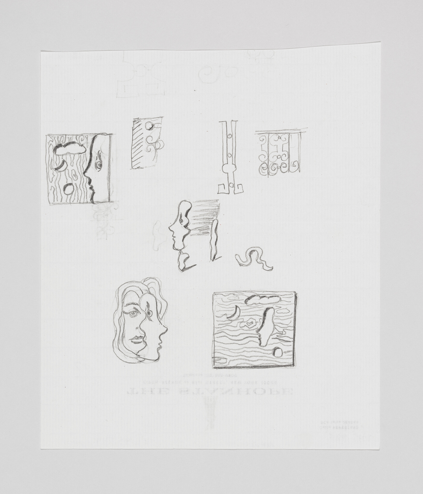 Pencil sketches of multiple stylized faces and decorative panel designs on a white sheet.