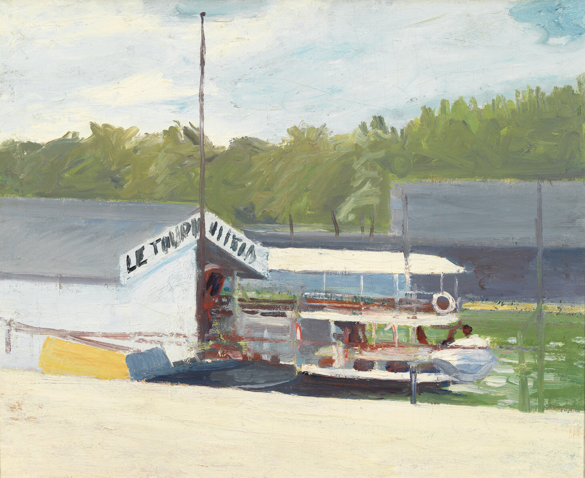 A small covered riverboat sits tied to a wooden dock beside calm water and trees.