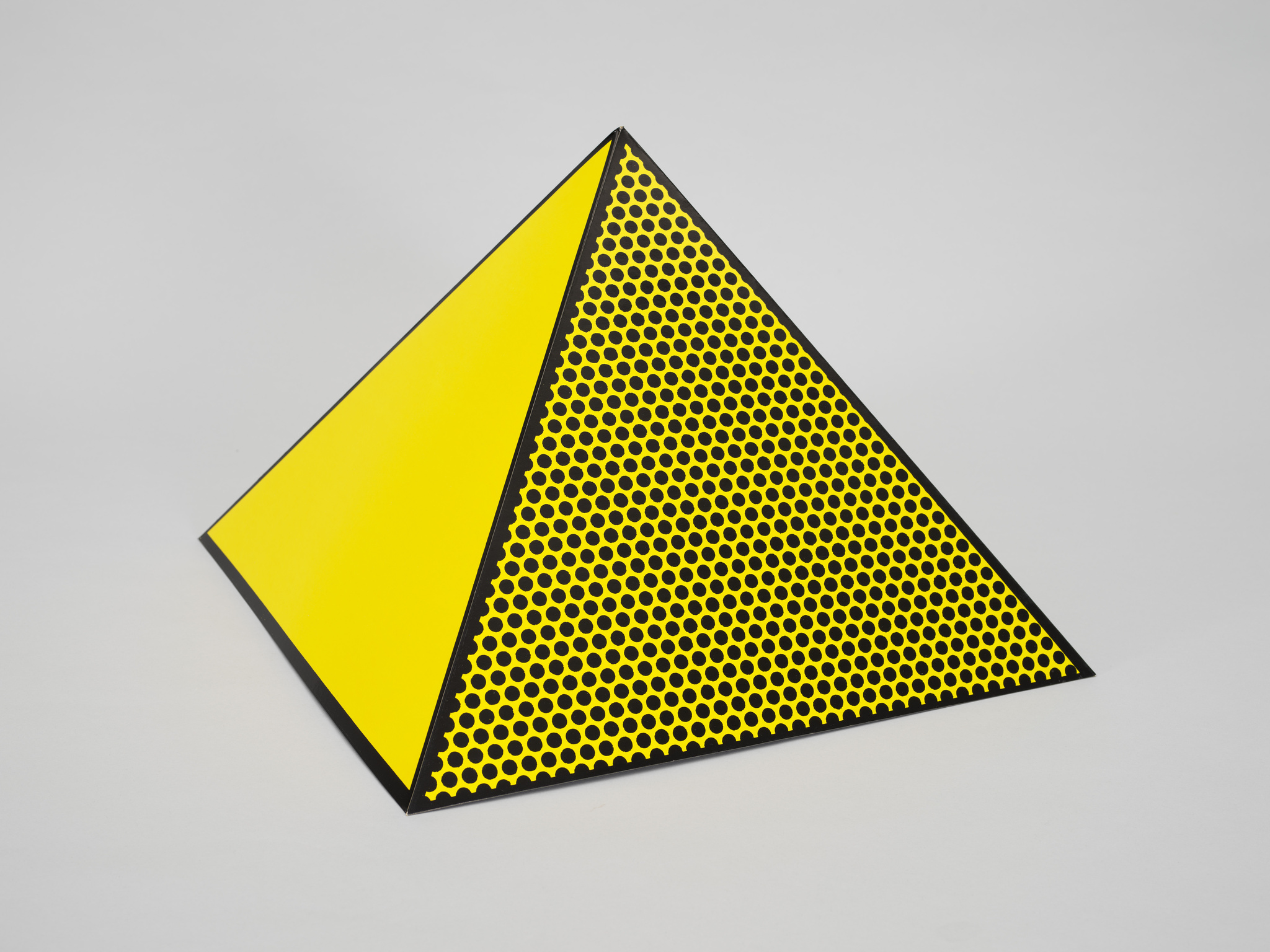 A vibrant yellow and black triangular pyramid with a pattern of black dots decreasing in size towards the edges, set against a neutral background.