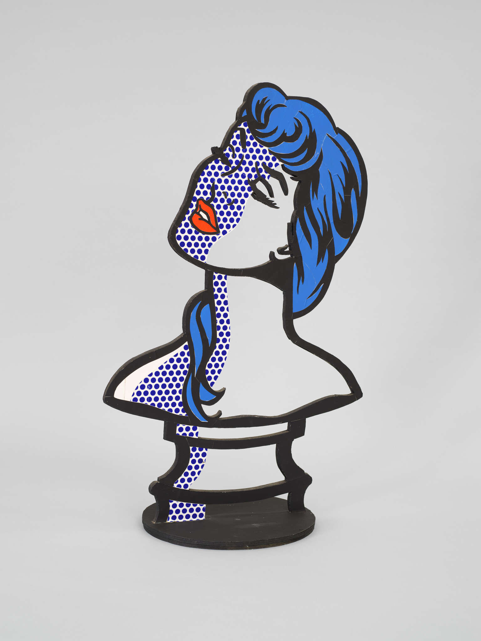 A stylized pop-art bust of a woman with blue hair, dotted skin, and red lips.