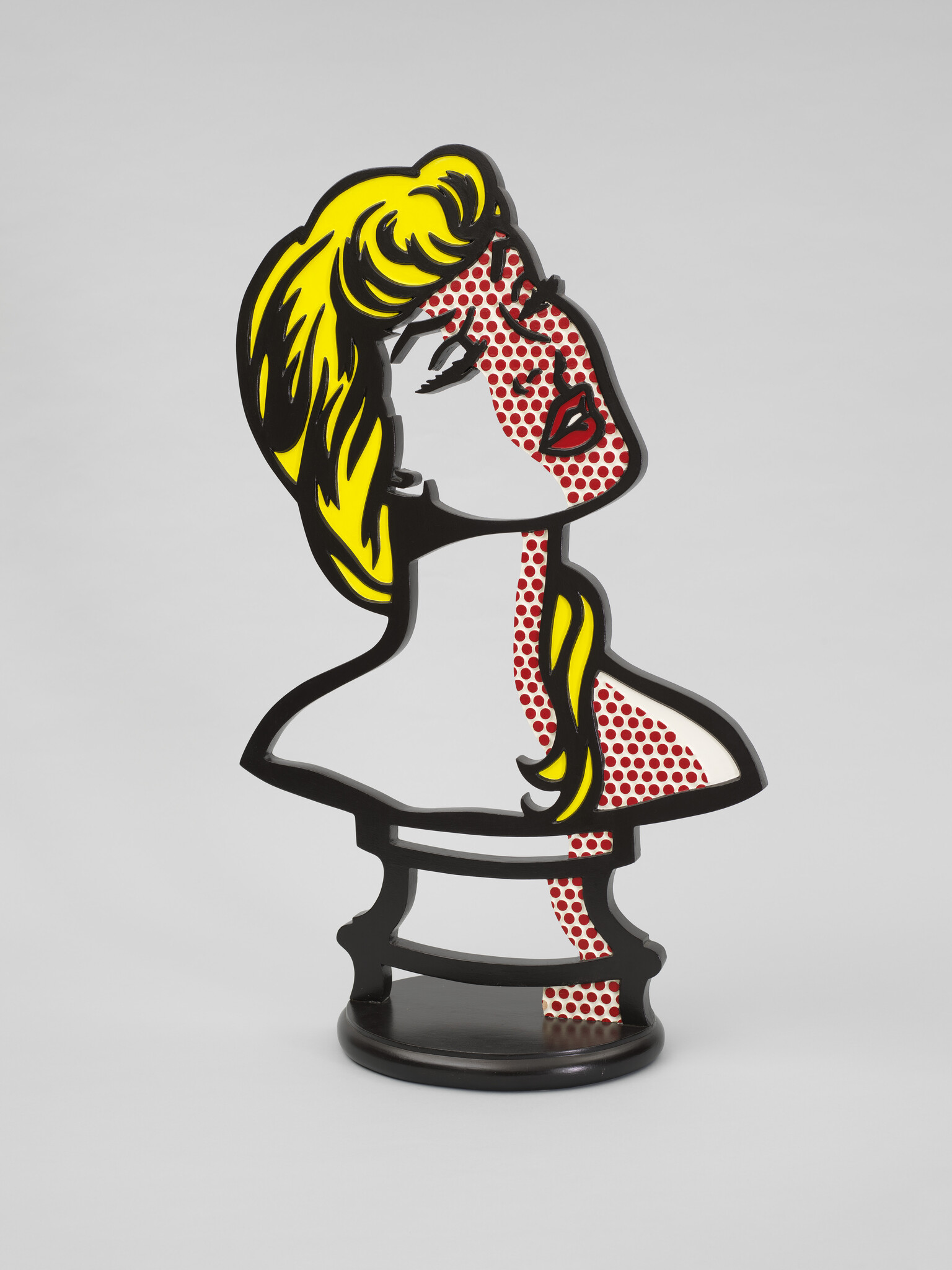 Stylized pop-art bust of a woman with yellow hair and red dotted skin on a black stand.