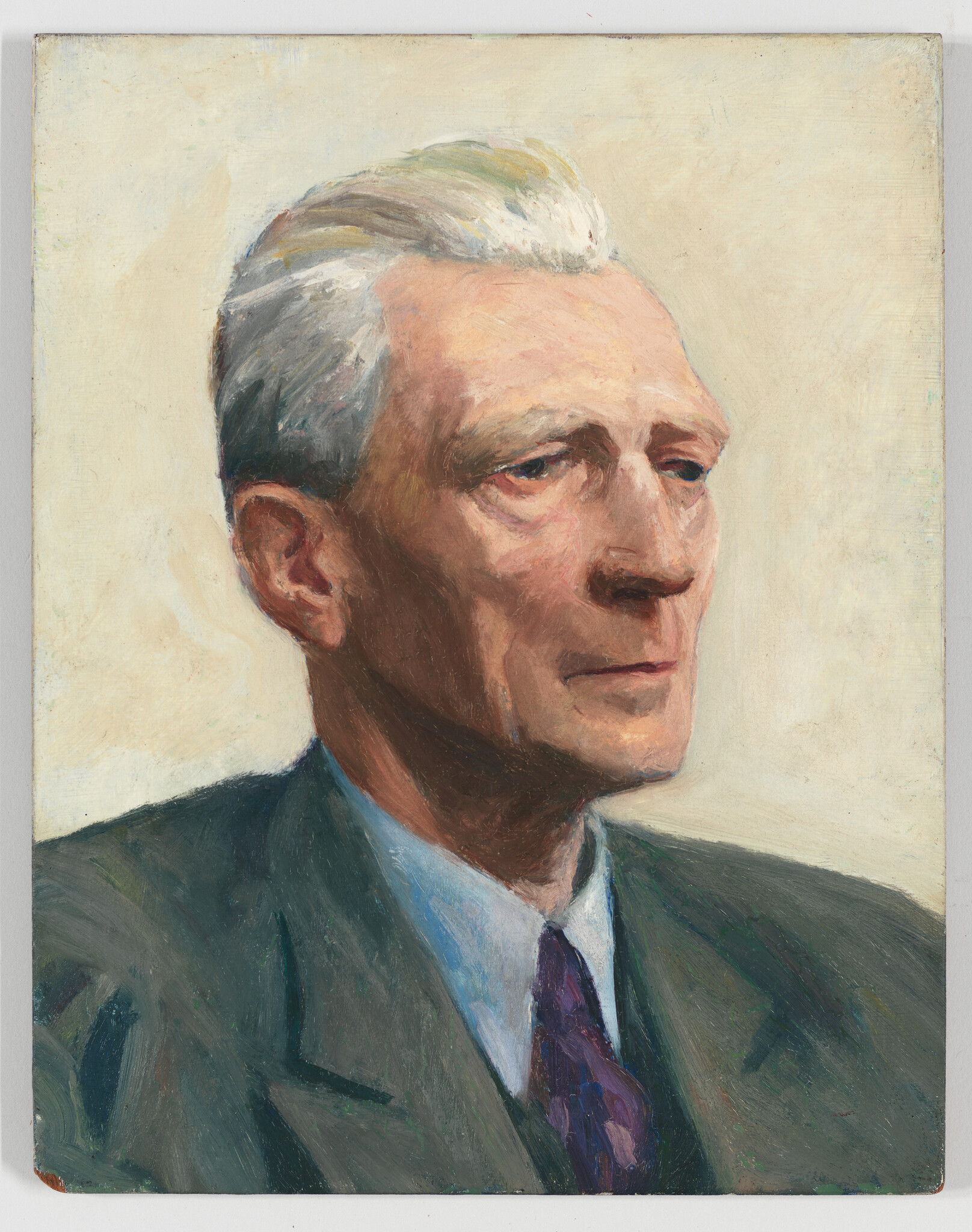 Elderly man with white hair wearing a suit and tie looking thoughtfully to the right.