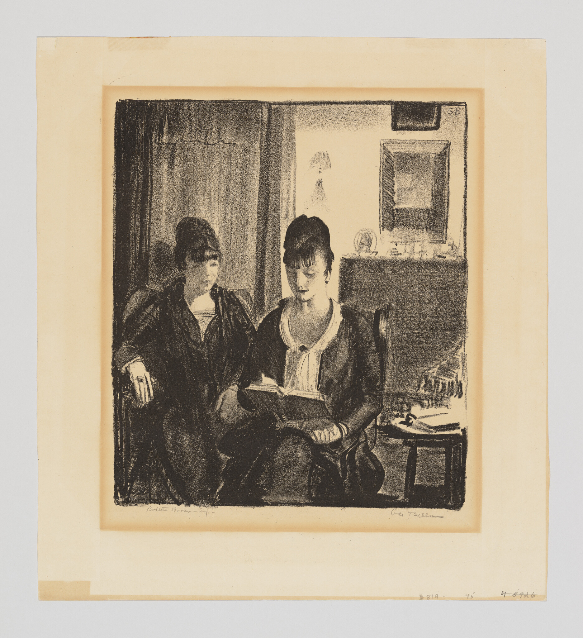 Two women sit on a sofa while one woman reads aloud from a book.