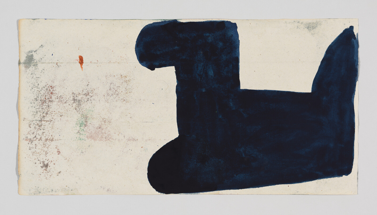 A large dark blue abstract shape covers the right half of a speckled off-white paper.