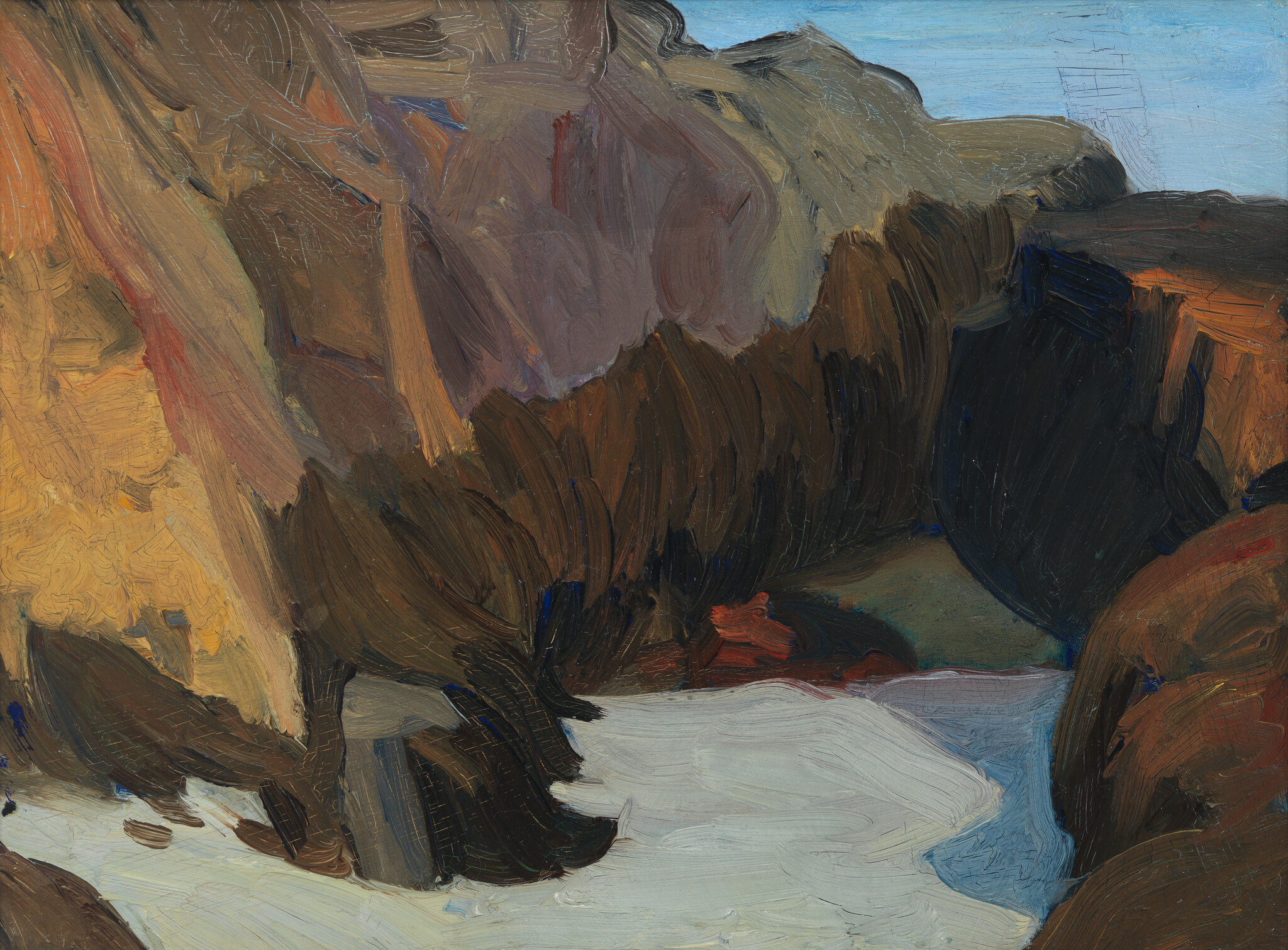 Snow and a small stream flow through dark rocky cliffs under a pale blue sky.