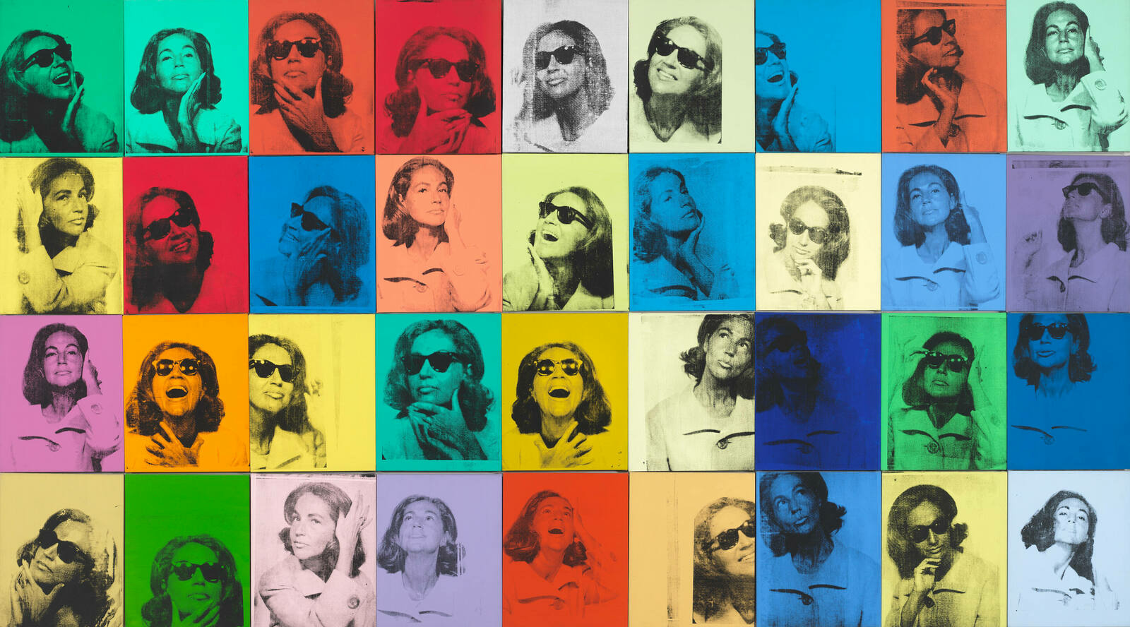 36 canvases in different bright colors with a black and white photo of a woman printed on each one.