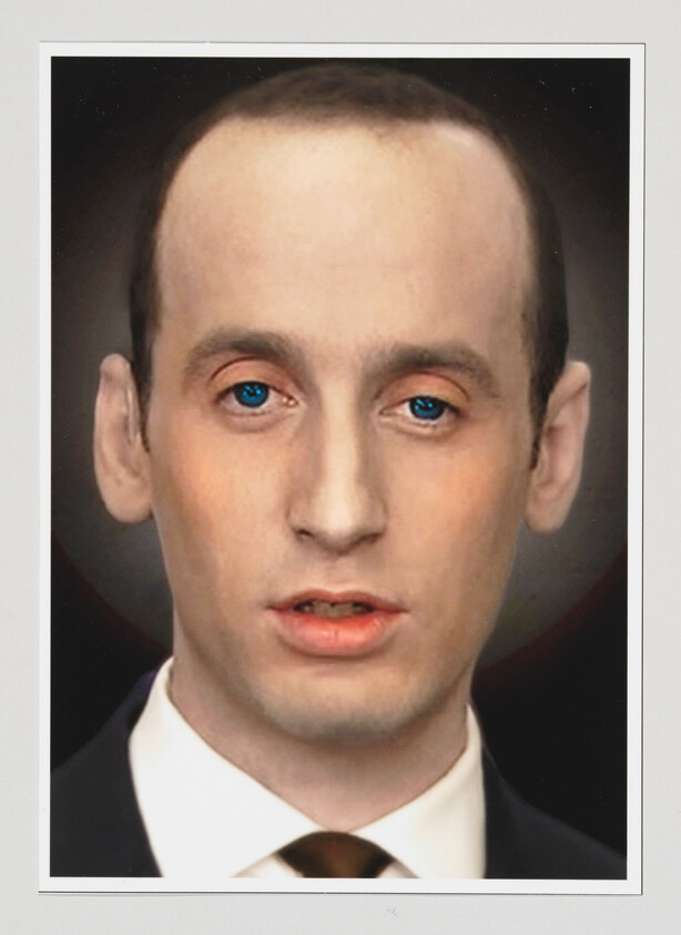 Young man in a suit and tie stares forward with blue eyes and a neutral expression.