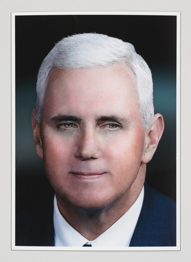 Close-up portrait of an older man with short white hair and a suit, wearing a neutral expression.