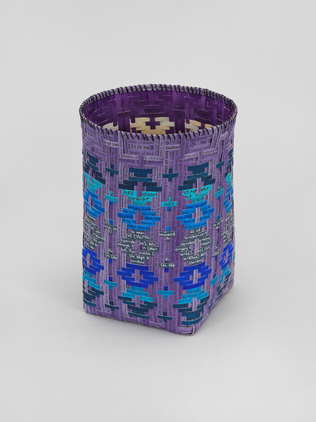 Tall rectangular woven basket with a purple base and blue geometric patterns.