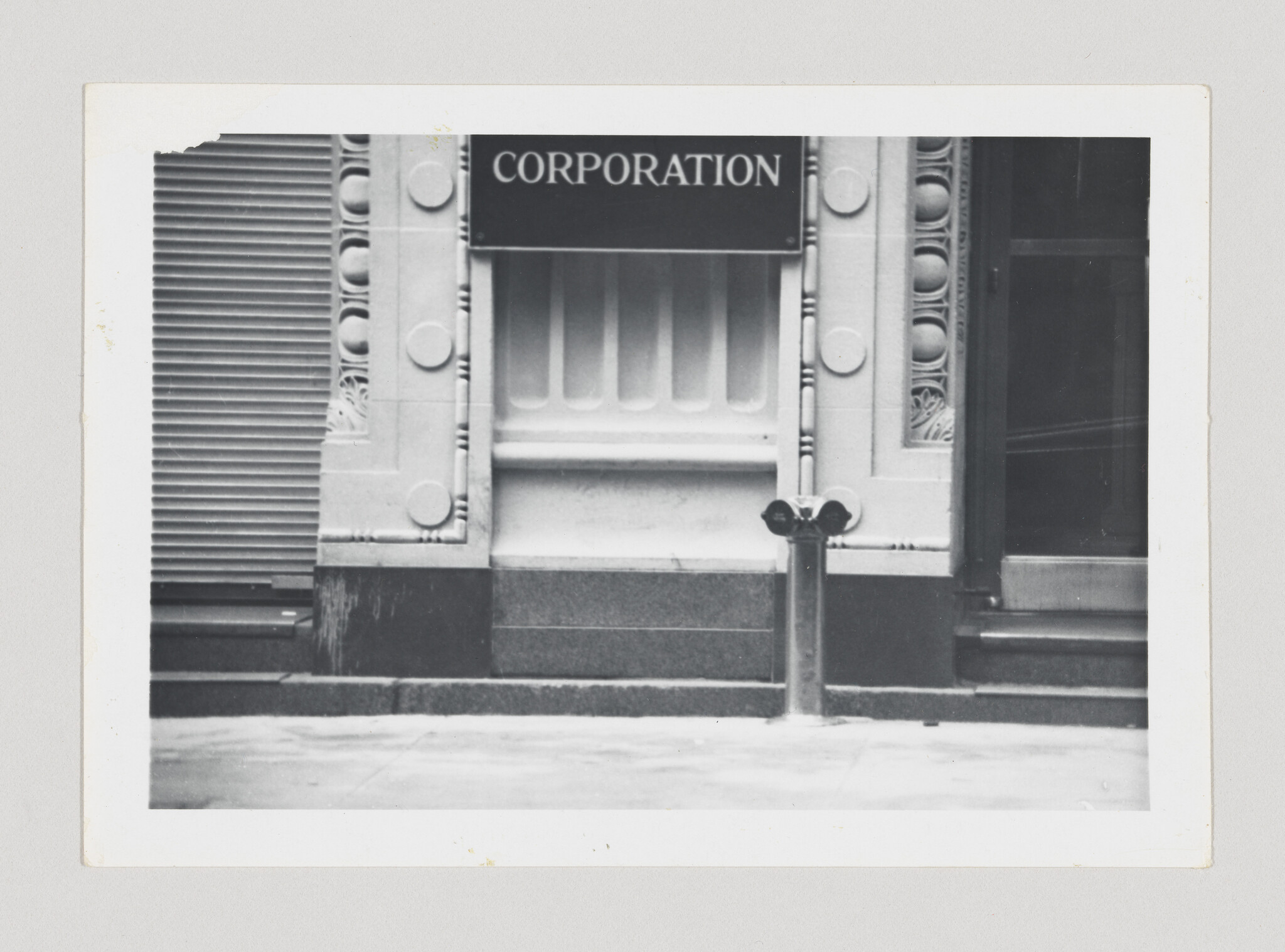 Decorative building entrance with a "Corporation" sign above and a twin-headed parking meter in front.