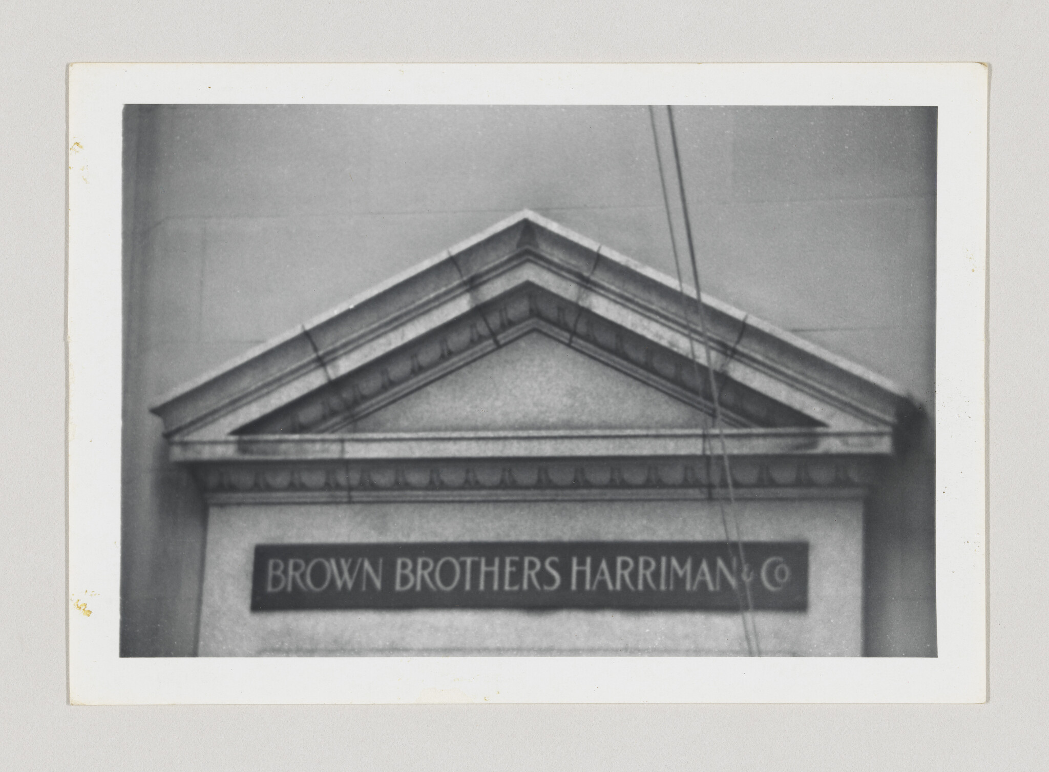 Stone building pediment above an entrance with a sign reading Brown Brothers Harriman & Co.