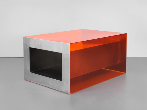A low rectangular metal and translucent orange acrylic table with a large hollow rectangular opening.