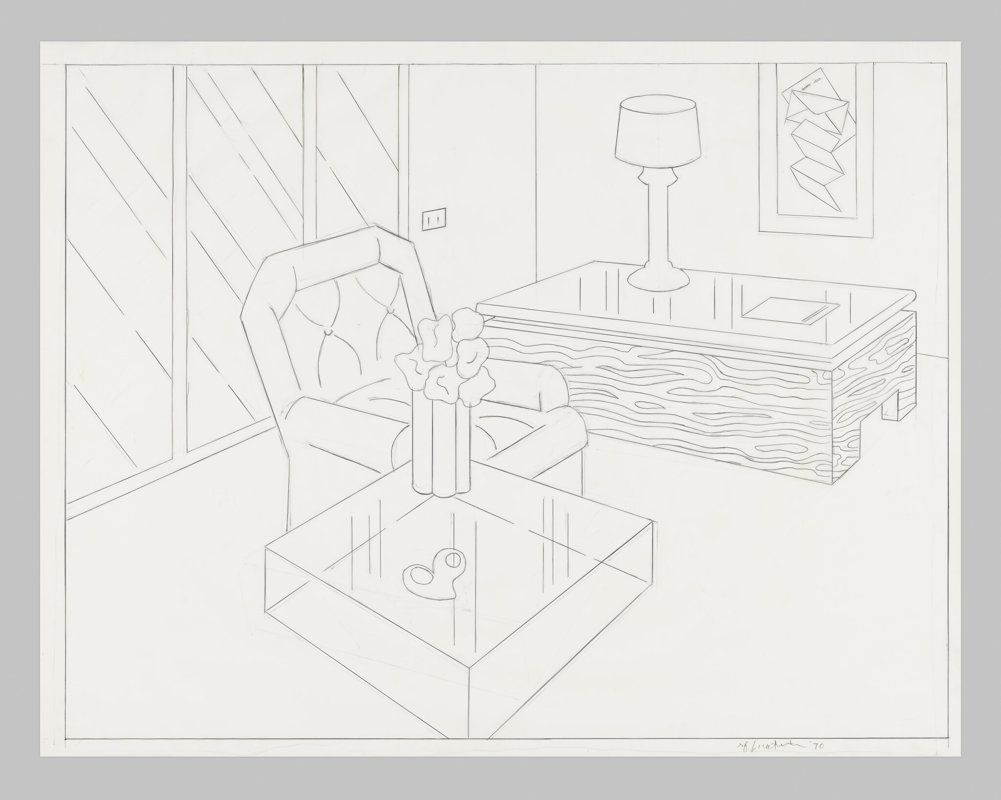 A simple living room with an armchair, coffee table holding a vase of flowers and a desk.