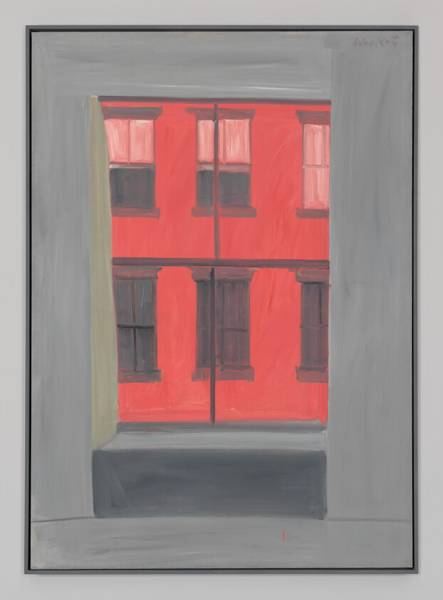 View through a gray window frame showing a red building with dark window shutters.