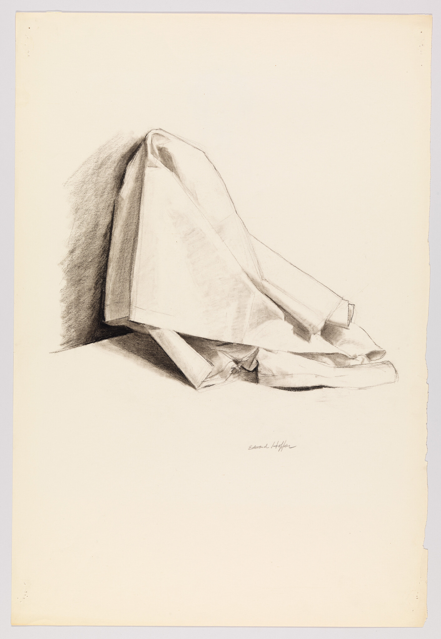 Draped cloth hanging over a corner with folded edges and deep charcoal shadows.