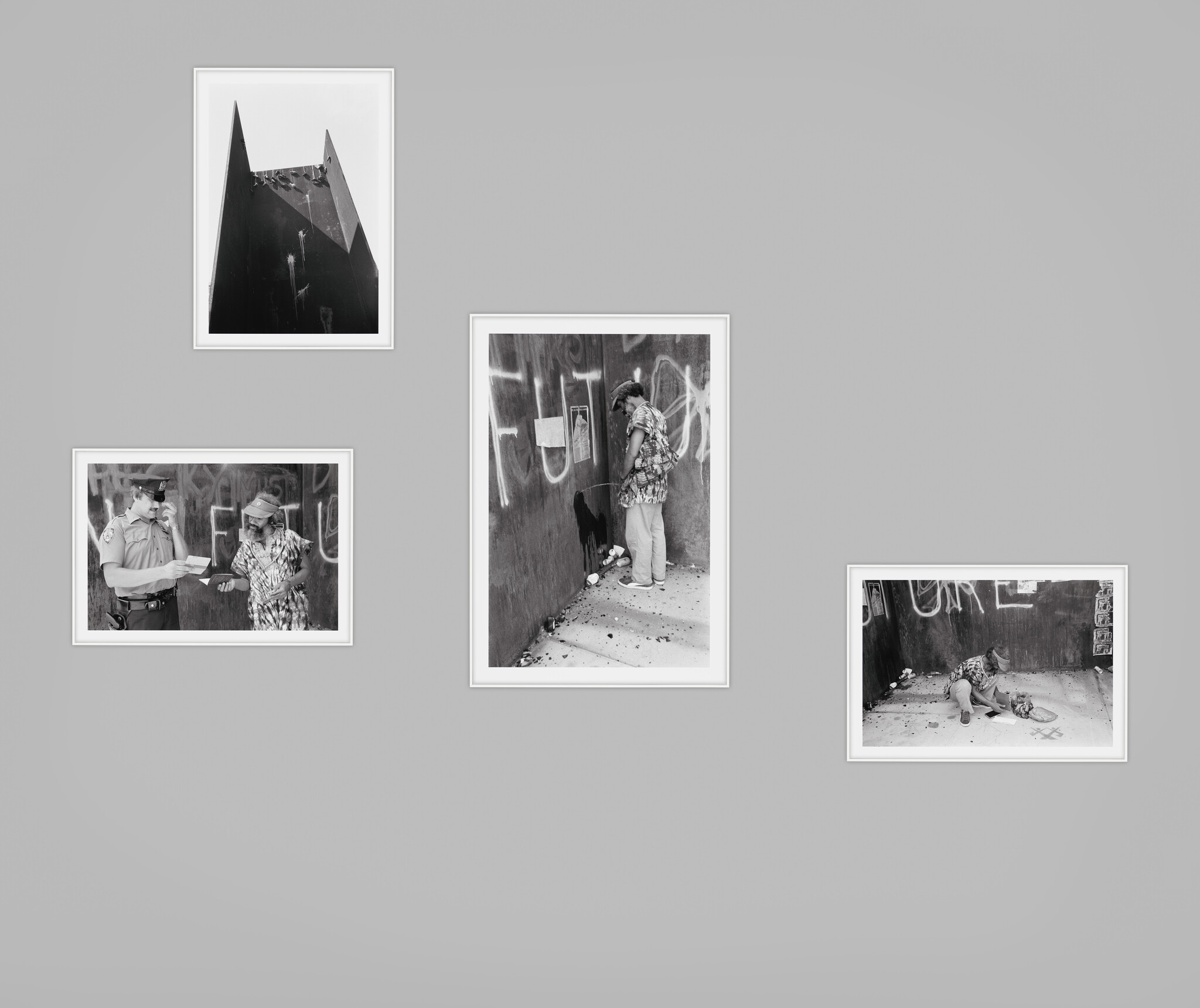 Photographs of steel sculpture. One with shoes dangling and three showing a Black man: urinating, crouching and with white police officer.