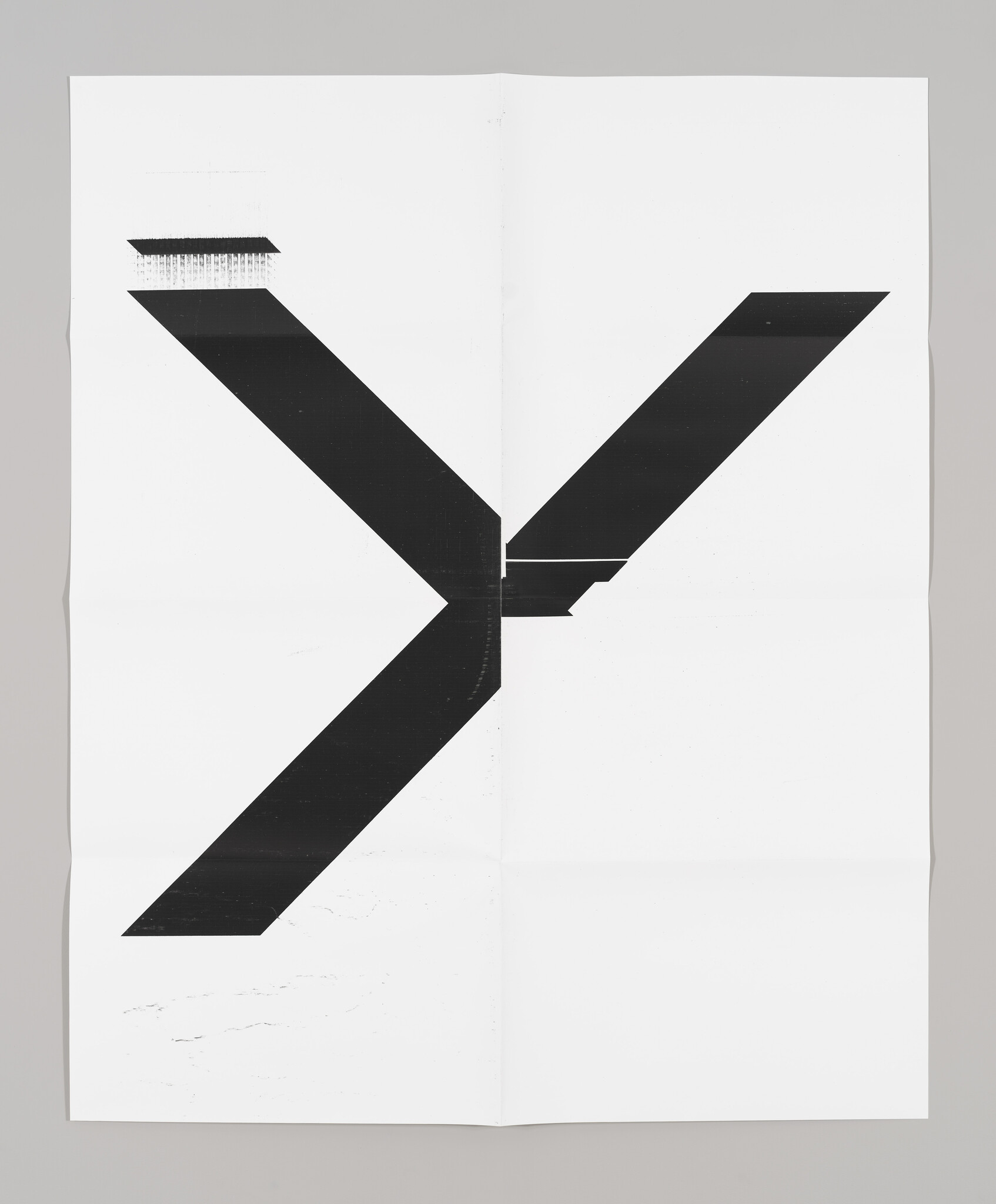 A black and white abstract artwork featuring a bold black 'X' shape that spans across a folded white paper, with the top left corner showing a textured brush stroke effect.