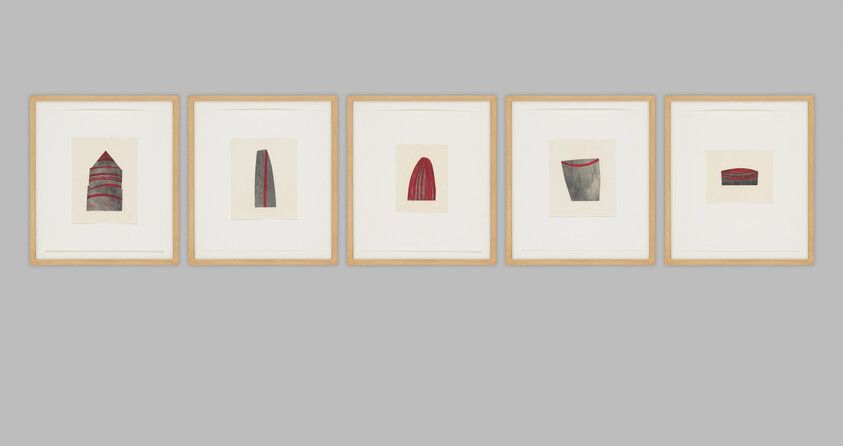Five framed minimalist abstract prints with red and gray shapes hung in a row on a gray wall.