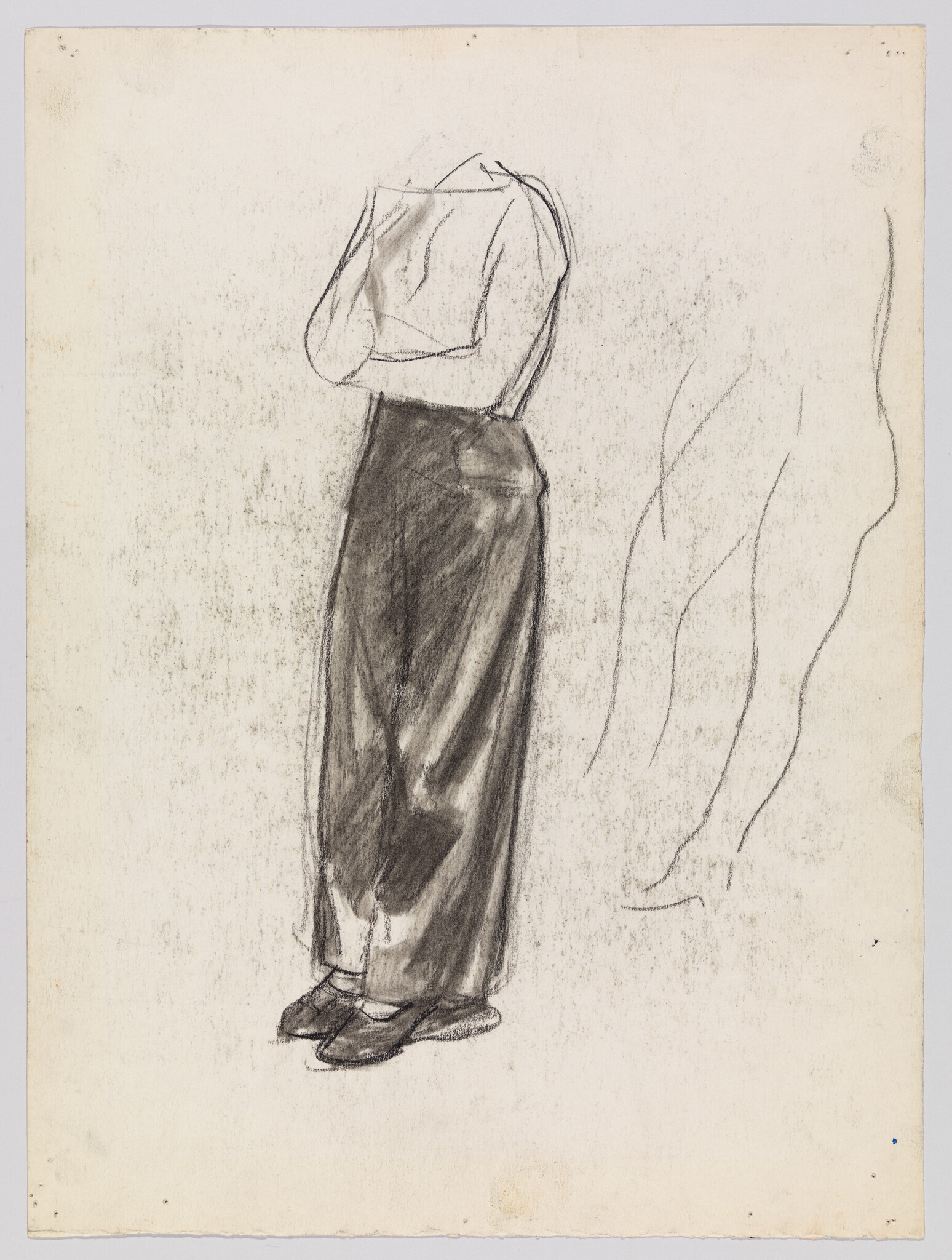 Sketch of a person viewed from behind, standing with hands clasped together. The figure is wearing a long skirt and a blouse, rendered in charcoal with light and shadow detailing. The background is blank with faint outlines of a similar figure to the right.