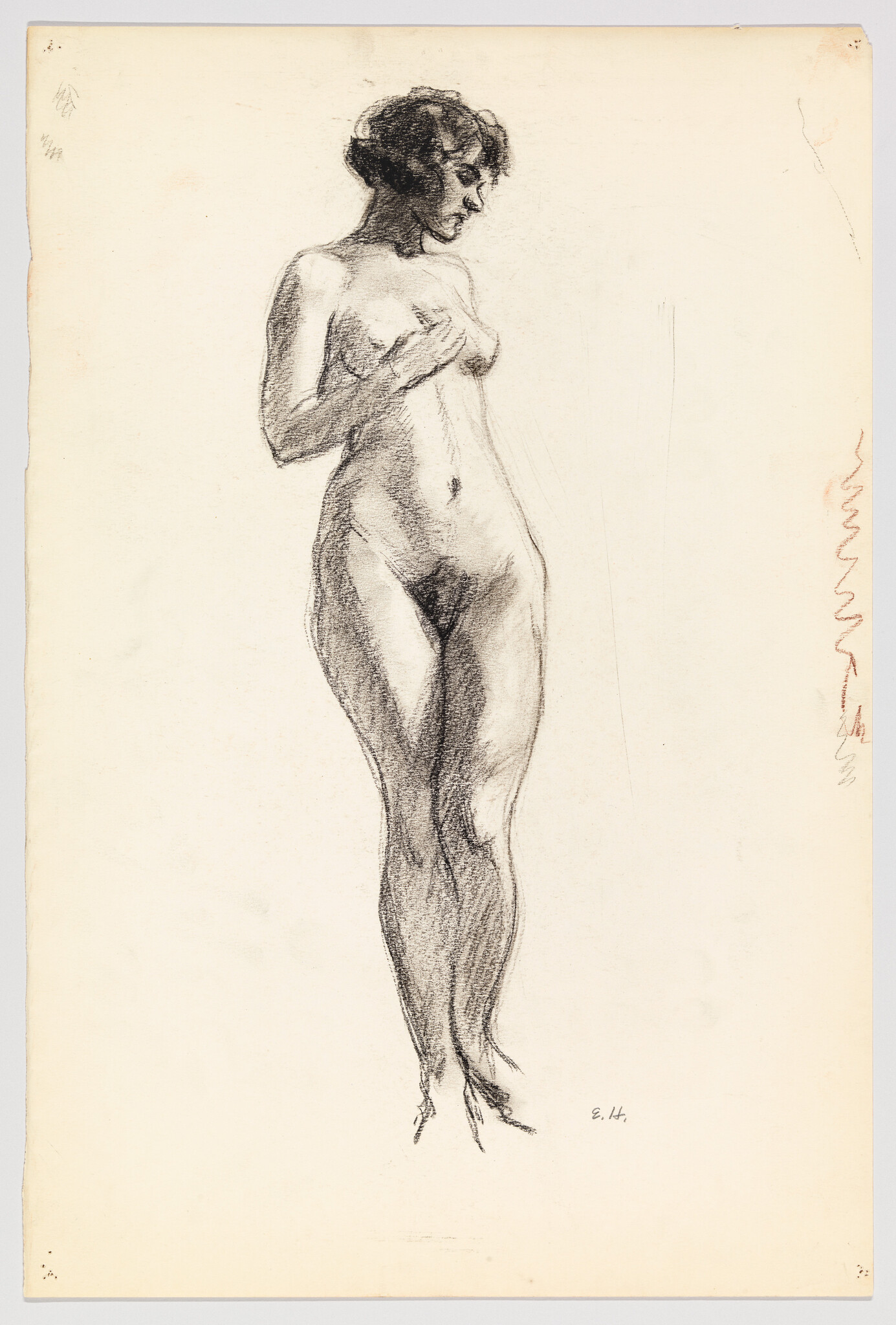 Standing nude woman in a charcoal sketch gently covering her chest with her hands.