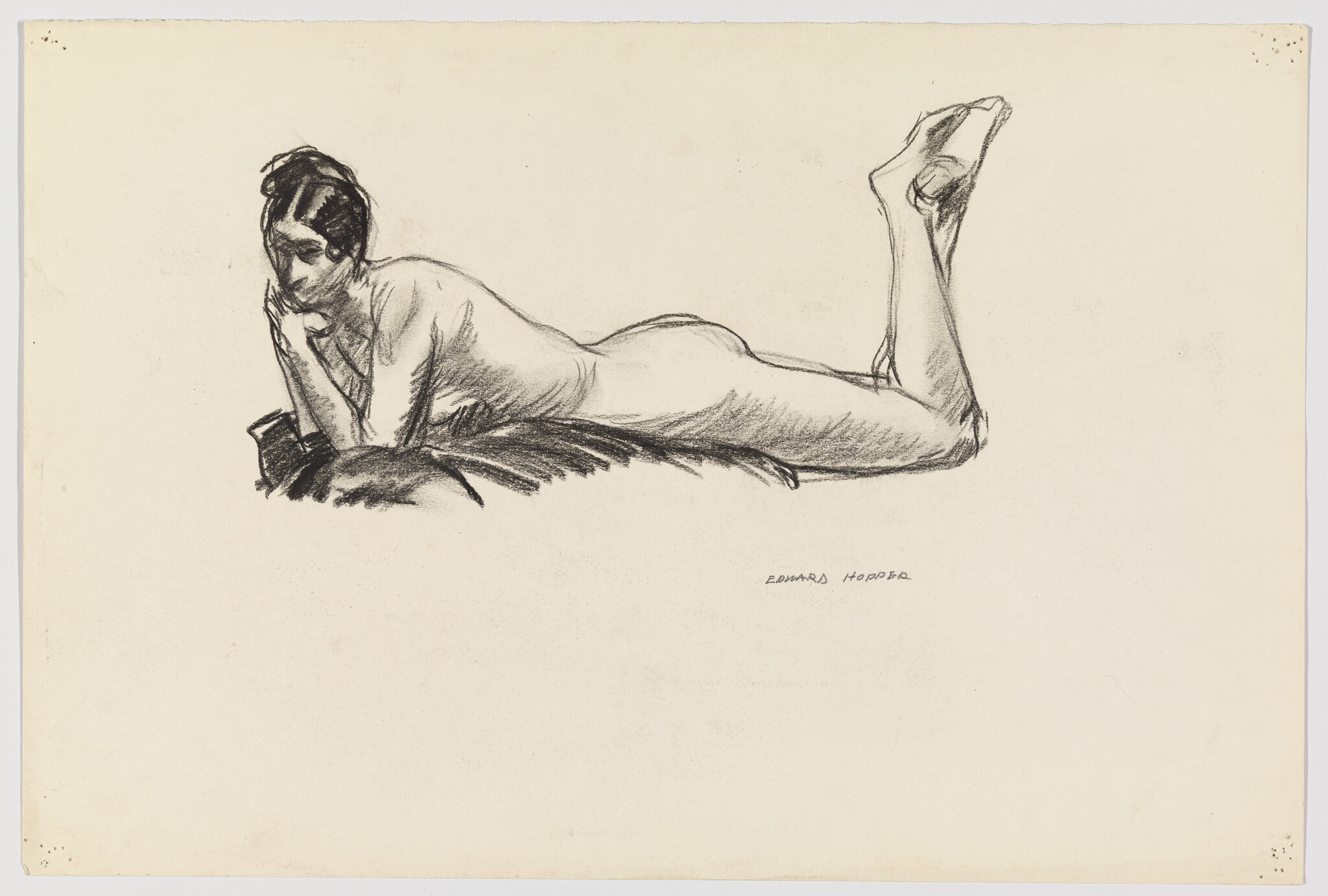 A charcoal sketch of a nude woman lying on her stomach with her feet raised.