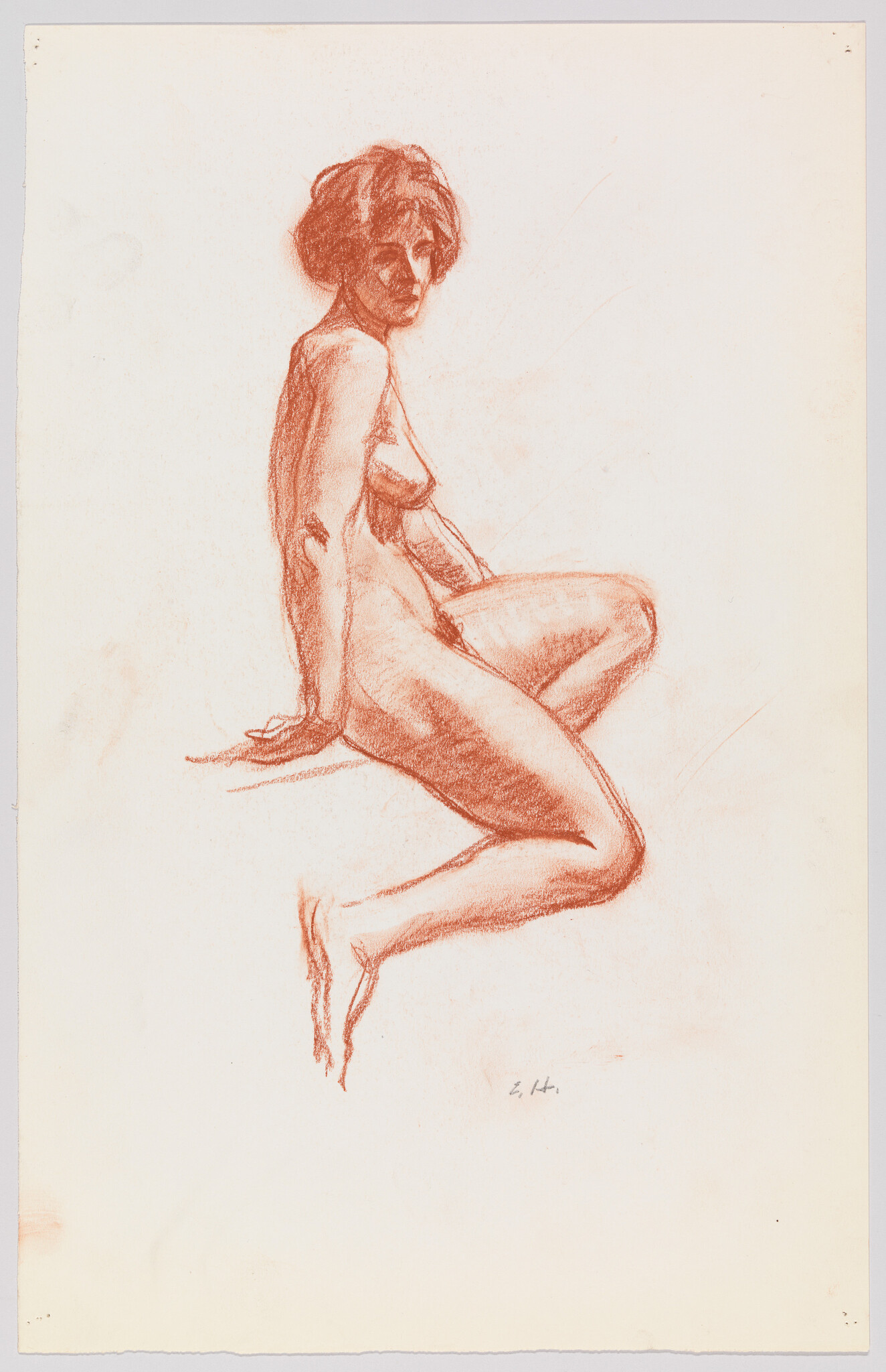 A seated nude woman poses on a low platform, looking over her shoulder.