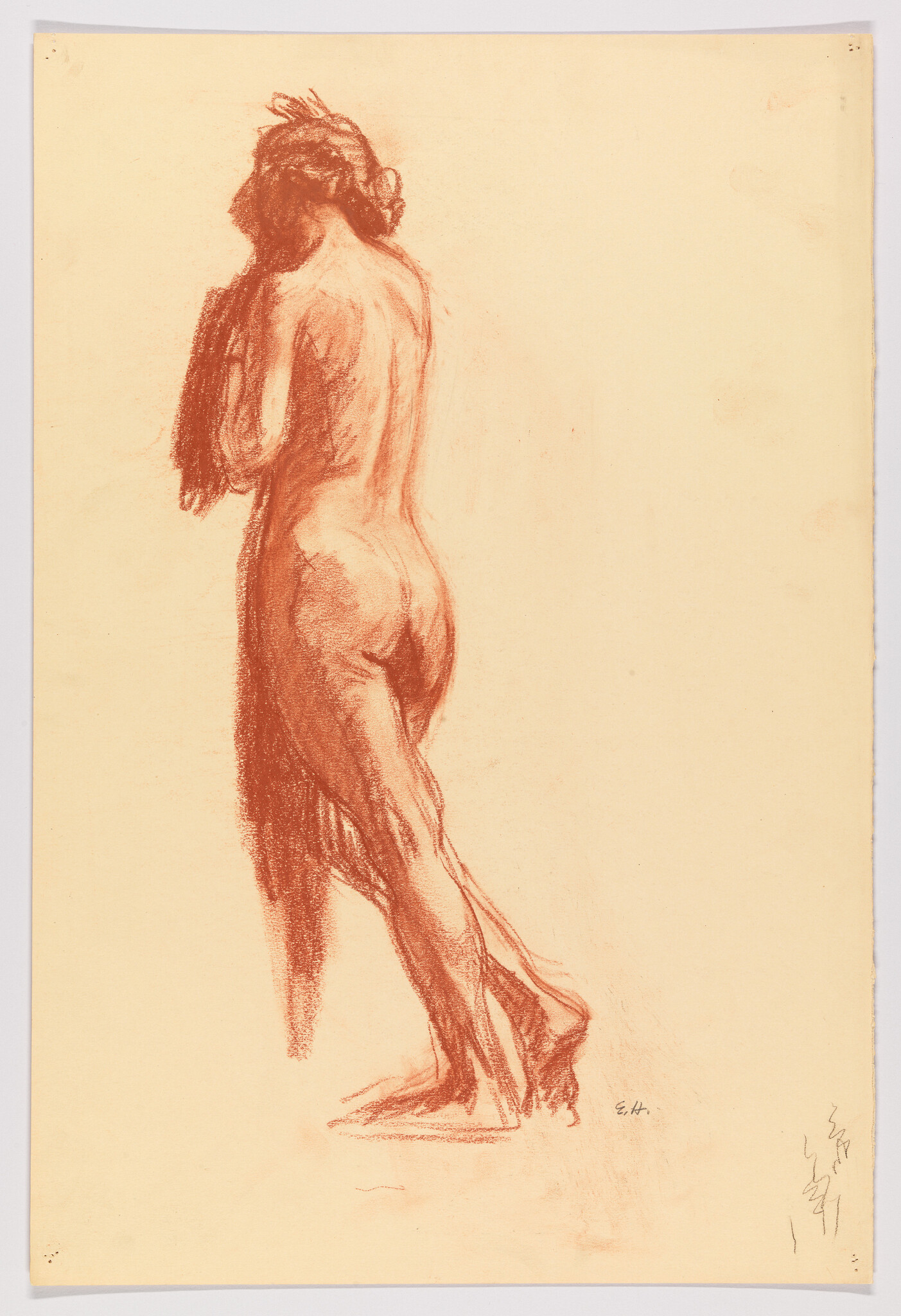 Standing nude woman seen from behind holding a cloth against her chest.
