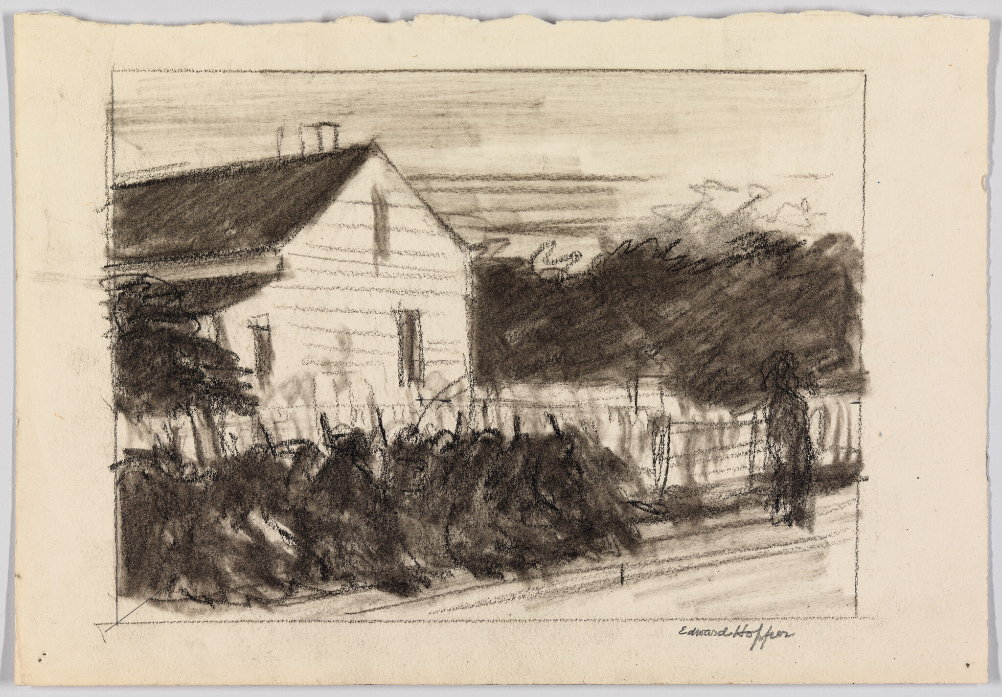 Small white house behind dense bushes and a fence with a lone figure standing nearby.