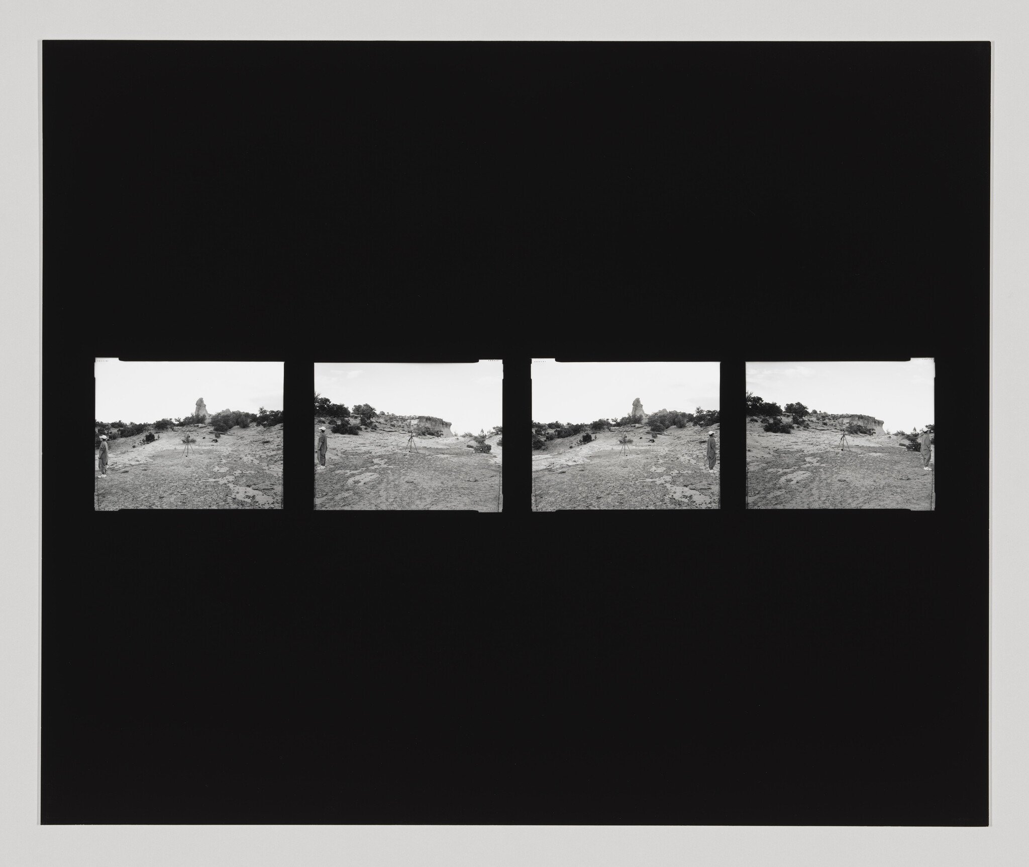 A series of five black and white panoramic photographs displayed in a horizontal row, each showing a slightly different angle of a hilly landscape with sparse vegetation under a bright sky, all set against a black background.