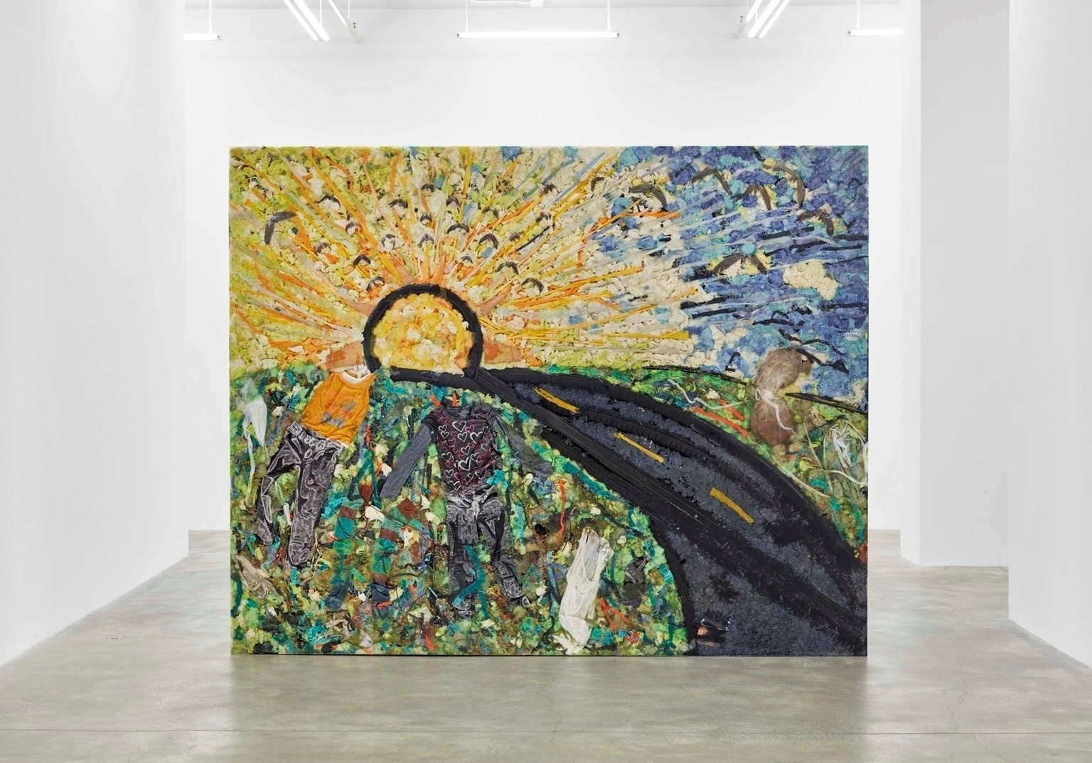 A black asphalt road cuts through a lush green hill and leads towards a glowing yellow sun outlined with a thick black circle. Yellow rays from the sun extend out into a blue sky. Two figures are situated in the field to the left of the road. The entire piece is intensely textured, created from mixed materials which include resin, Virginia soil, du-rags, rubber tires, and others.