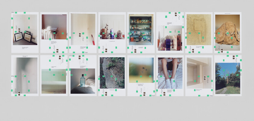 A series of sixteen rectangular photographs in two rows of eight. Some of these photographs have visible dents and writing, and there are green tape squares and postage stamps stuck to the photographs.