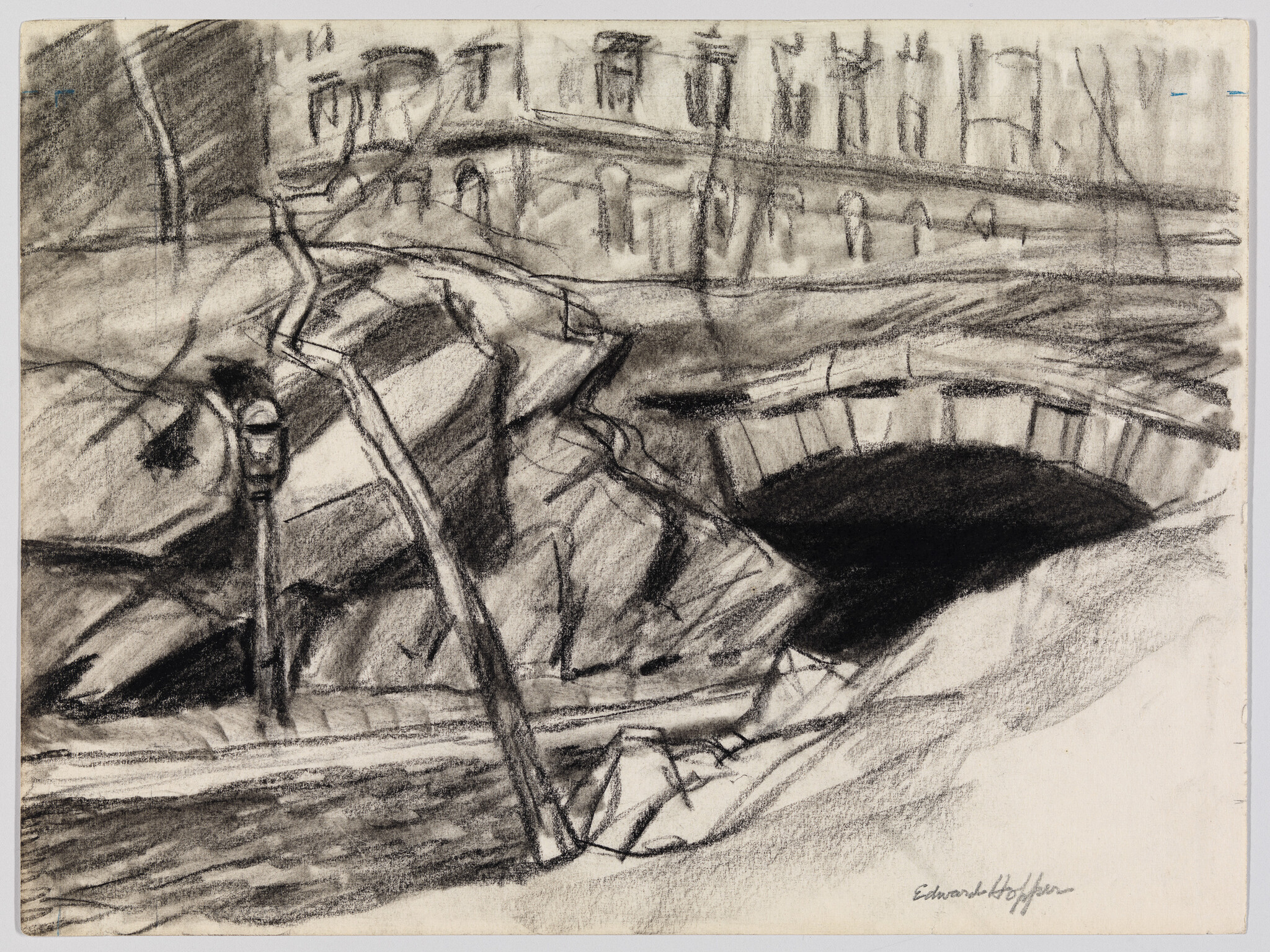 Stone arch bridge over a dark river with rocks and a leaning streetlamp.