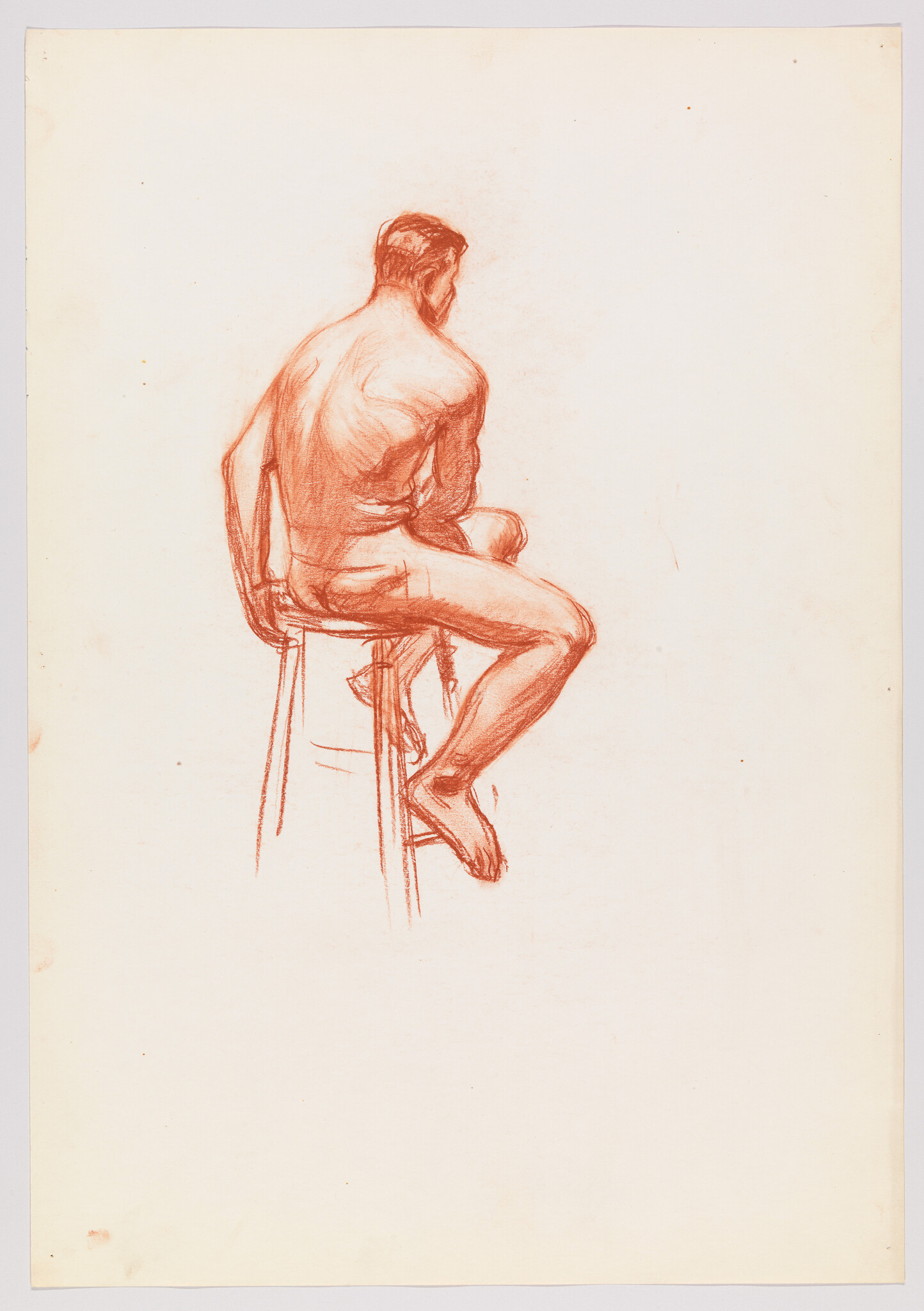 Nude man sitting on a stool with his back turned, one leg crossed and foot resting.