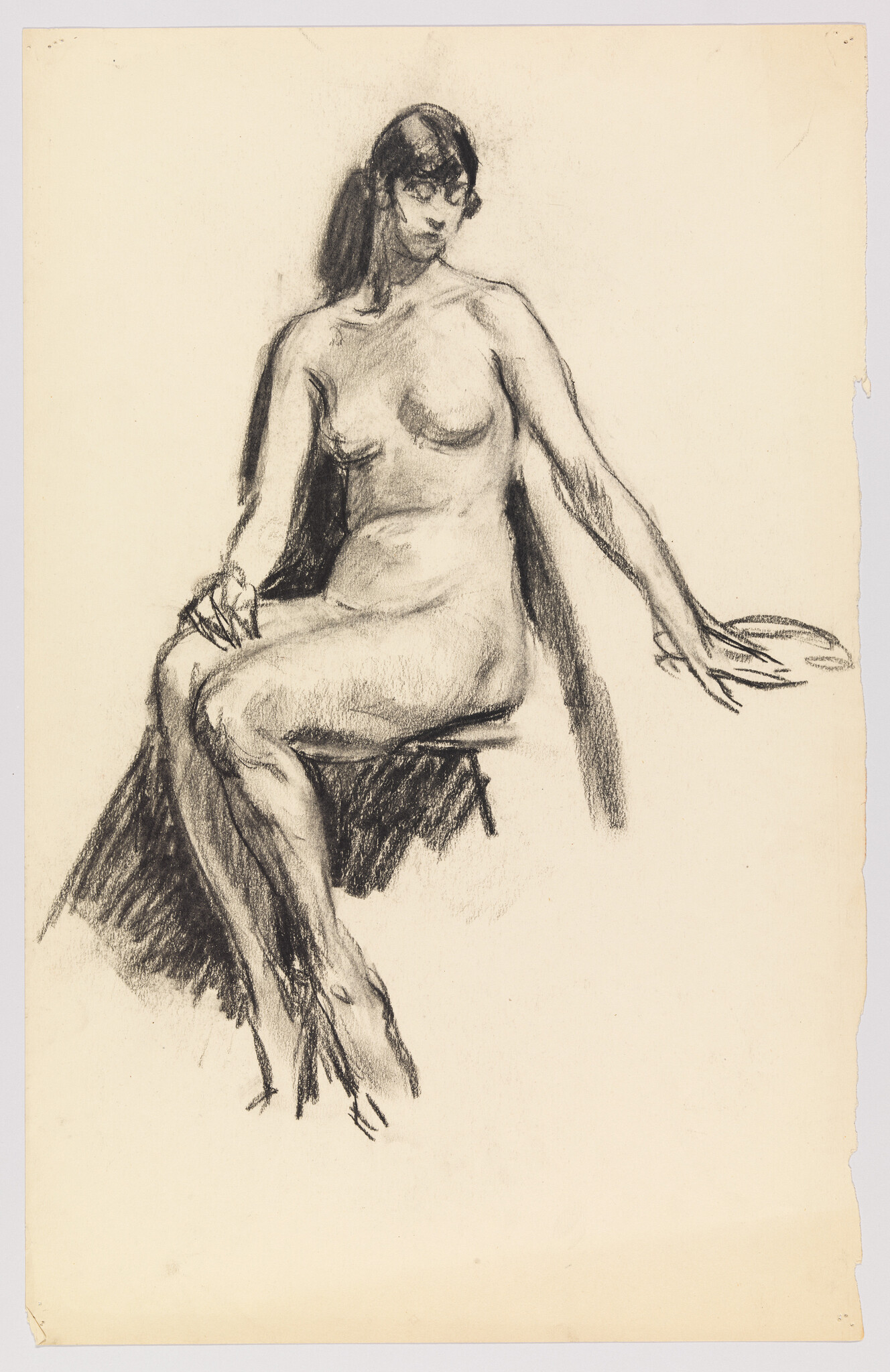 A charcoal sketch showing a seated nude woman with one arm resting and legs crossed.