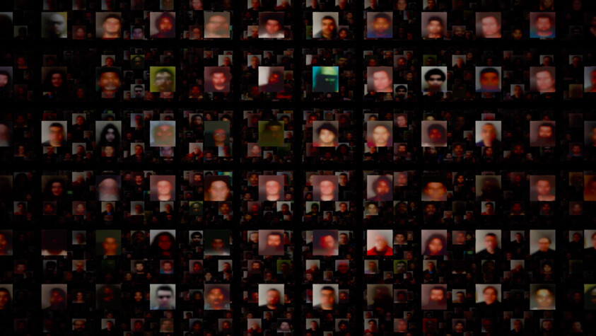 A grid of blurred, pixelated faces on a dark background, each face varying in color and expression, creating a mosaic-like pattern.