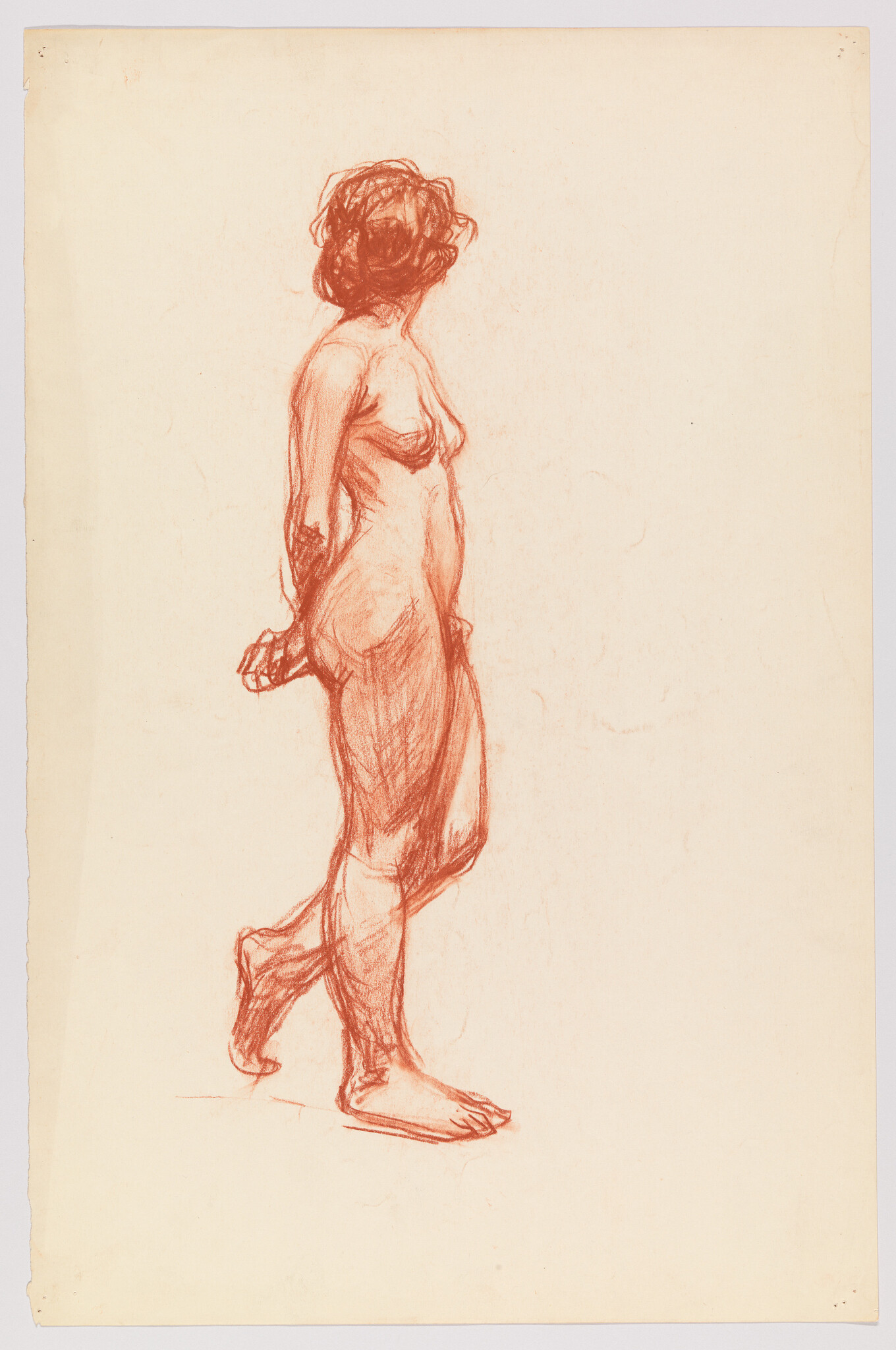 Nude woman standing with hands clasped behind her back, weight on one leg.
