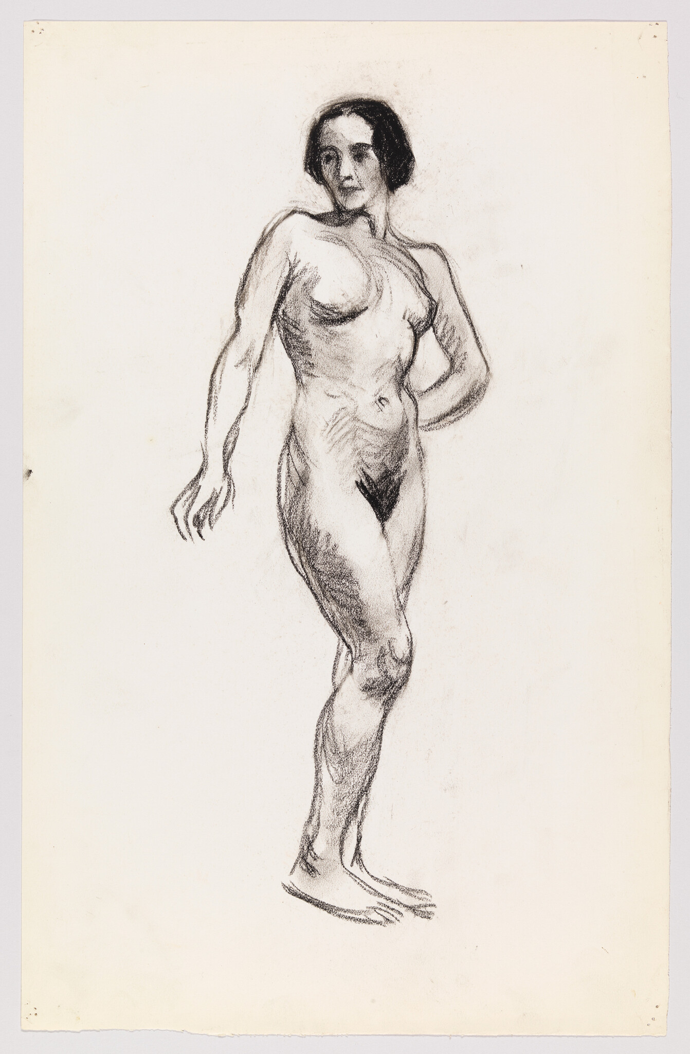 A charcoal sketch of a standing female figure with one arm akimbo and the other extended, set against a plain background. The drawing emphasizes the form and anatomy of the human body with visible strokes and shading.