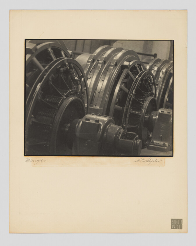 Large industrial generator rotors with coils and gears lined up in a factory setting.