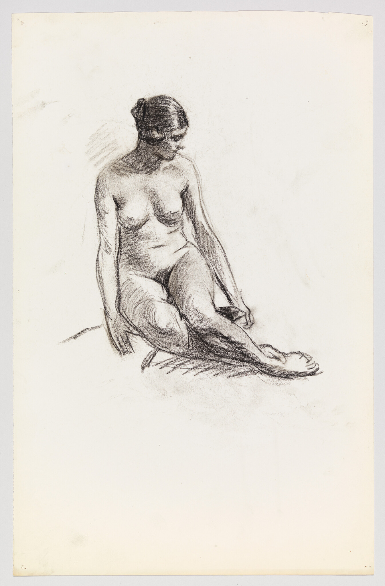 A seated nude woman looks down with hands resting and one leg extended.