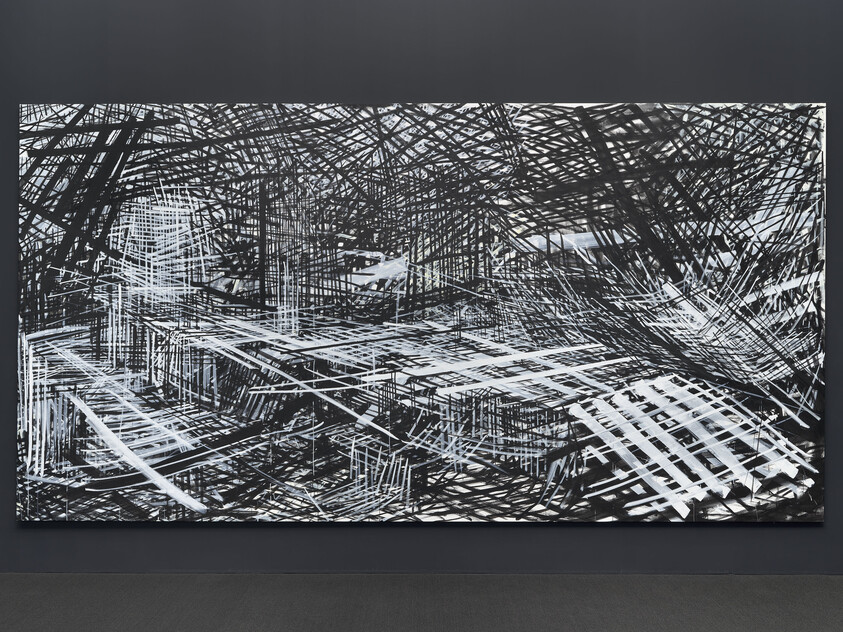 Harsh black and white lines fill the canvas forming box-like shapes and a hectic, claustrophobic atmosphere.