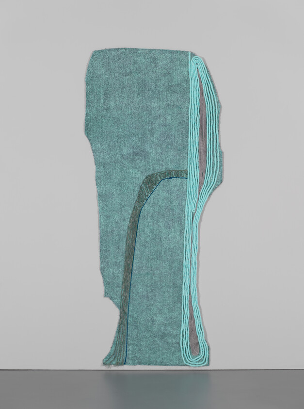 Tall teal textile wall hanging with layered turquoise rope outline mounted on a plain gray wall.
