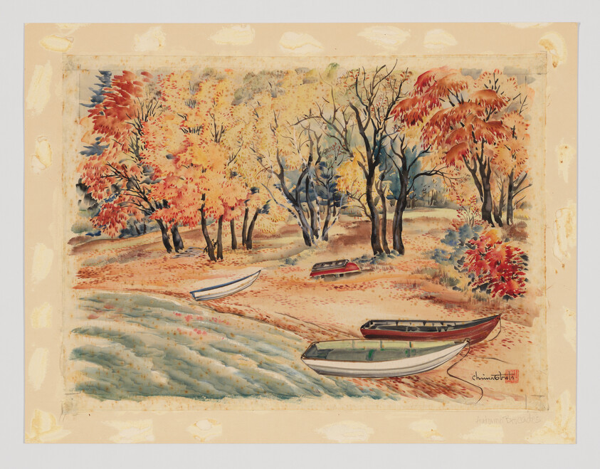 Several small rowboats rest on a sandy shore beneath trees with bright autumn leaves.