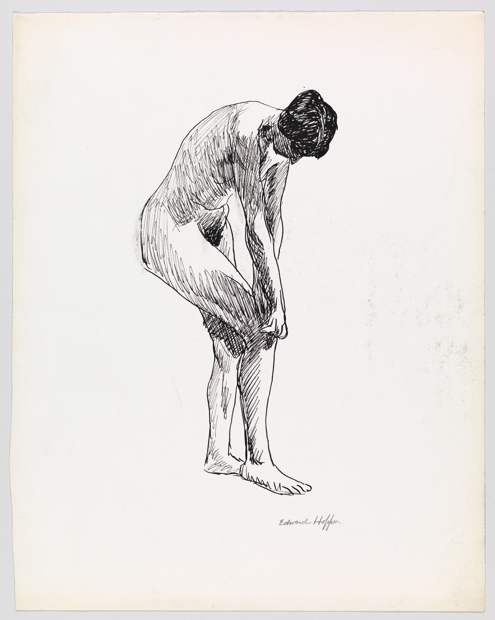 A standing nude woman bends forward, reaching down to adjust her lower leg.