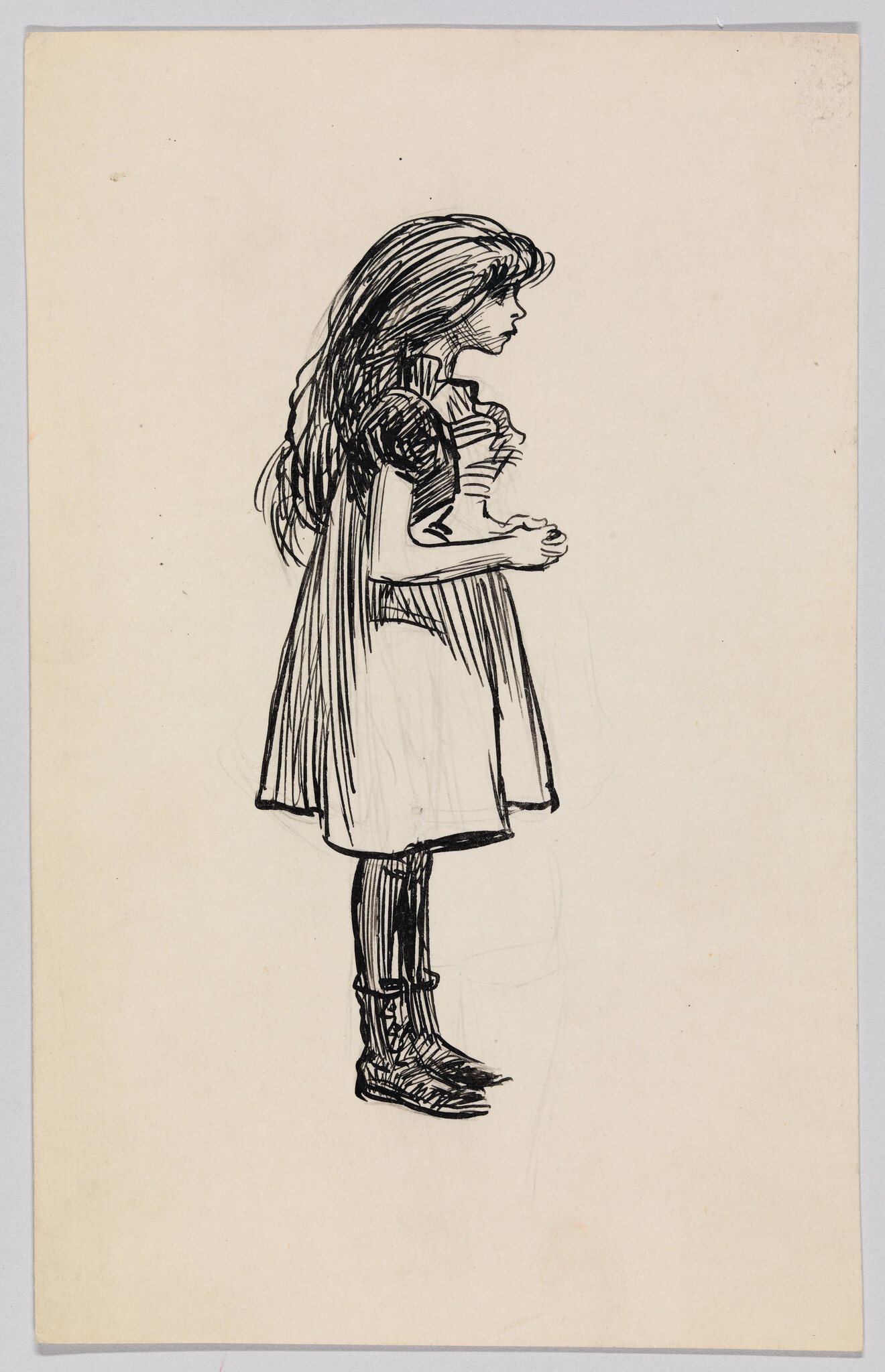 Young girl in a dress stands in profile with hands clasped at her chest.