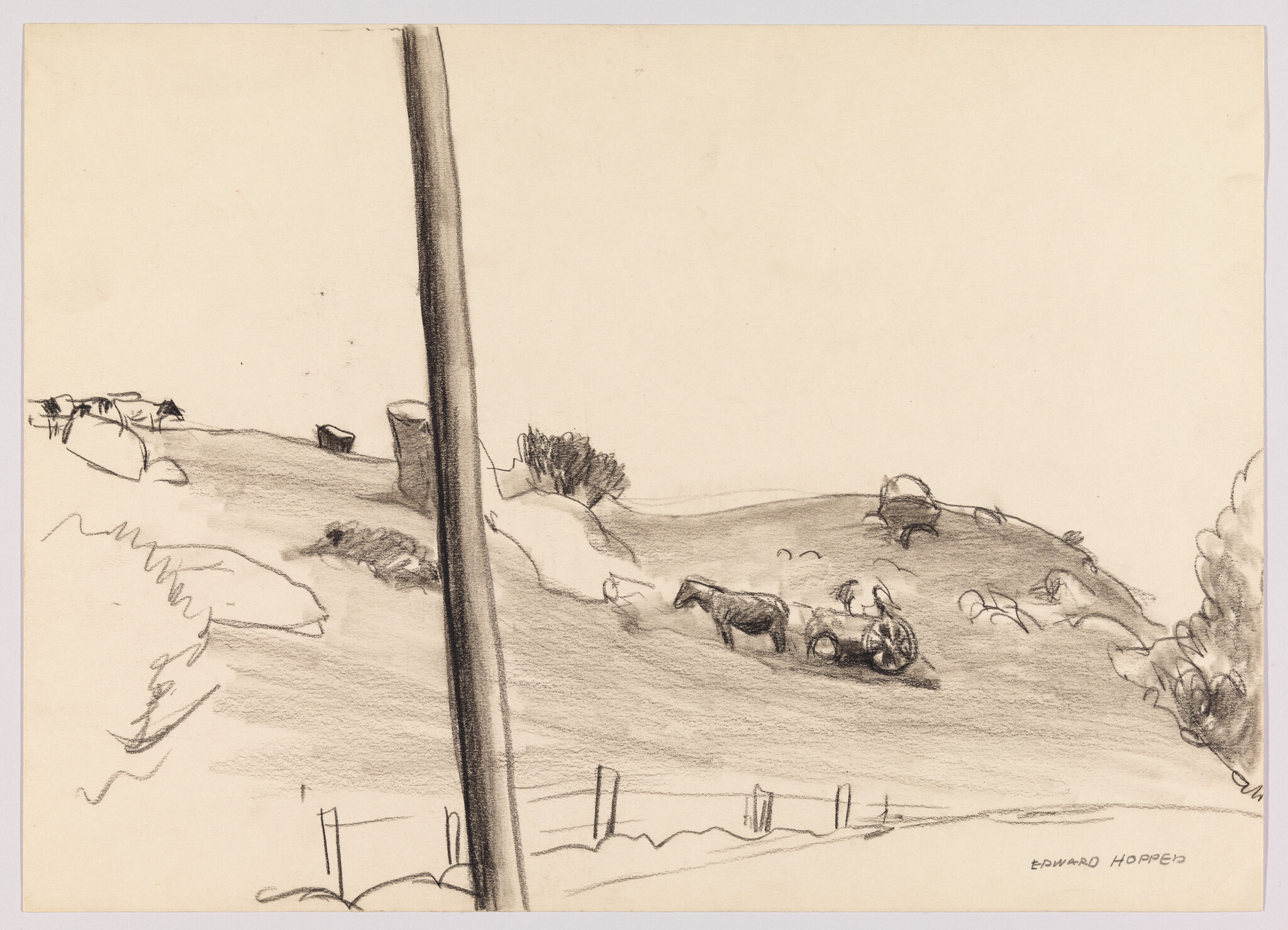 A tall utility pole in the foreground with horses pulling a cart on a distant hillside.