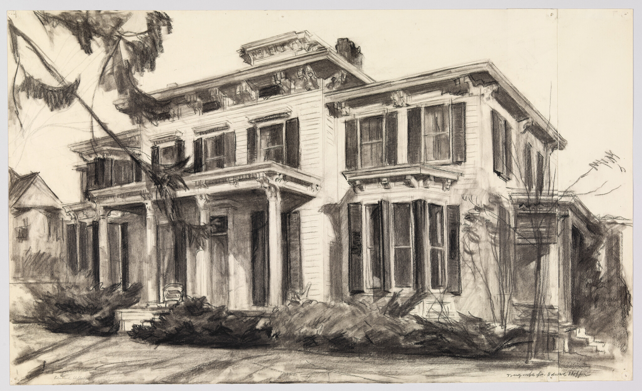 A large two-story house with a columned porch, shuttered windows, and overgrown bushes.